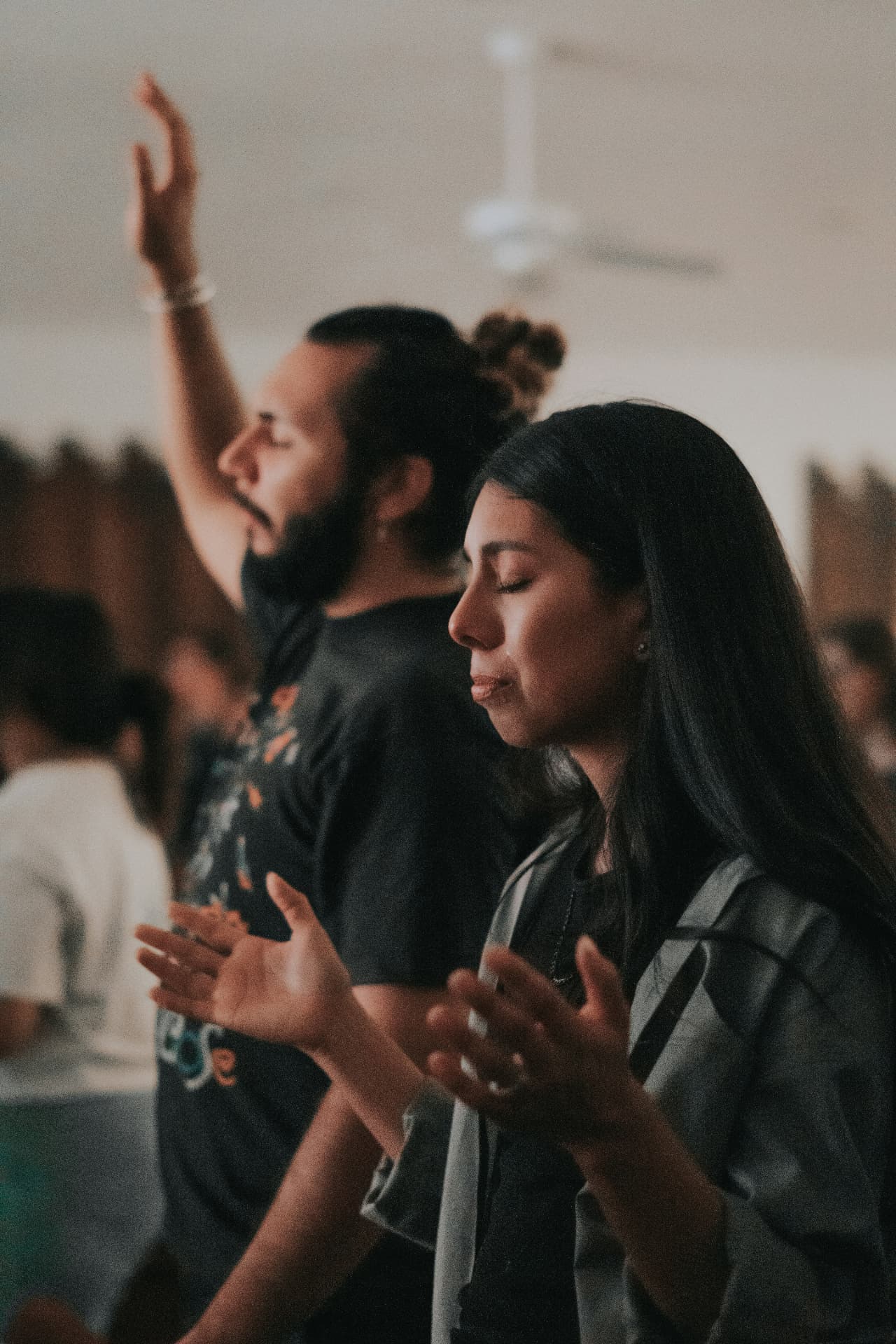 People worshipping together with hands raised