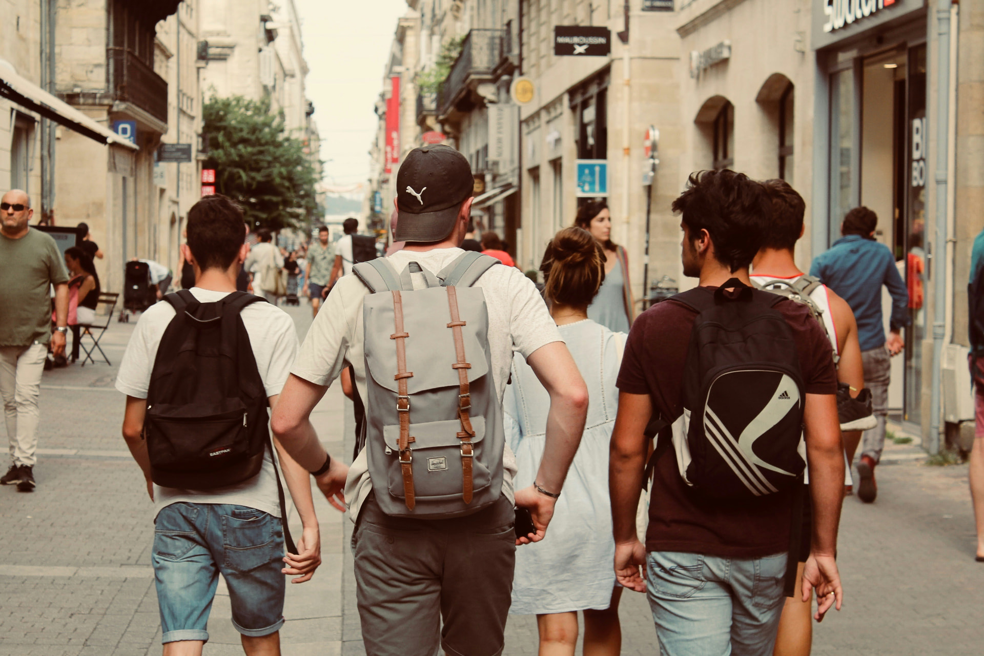 Students walking together through the city with backpacks