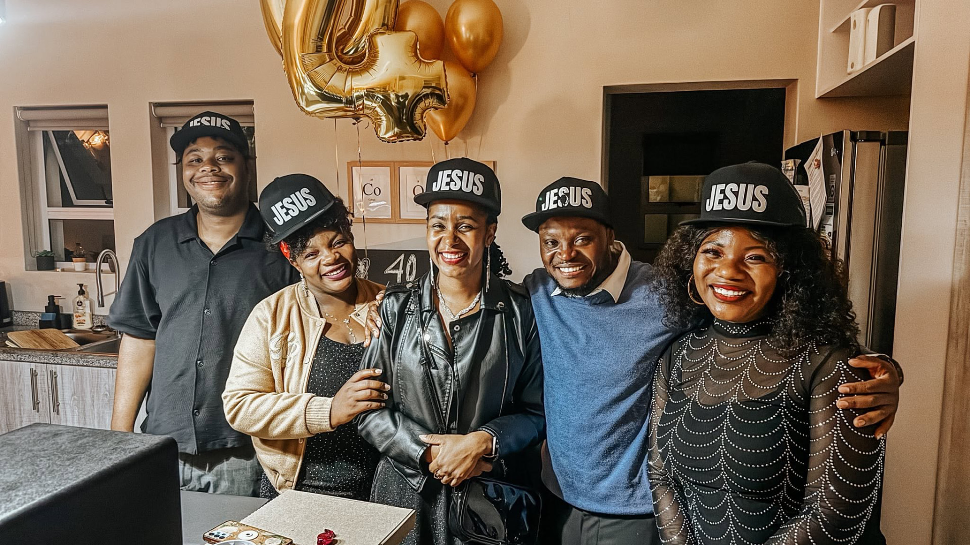 Friends celebrating together in Jesus caps at a home gathering